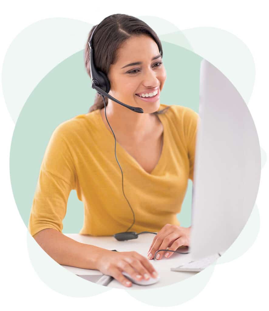 A virtual receptionist at an answering services company taking a phone call.