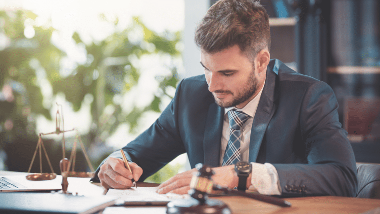 Professional attorney in a suit managing legal documents at a desk, symbolizing expert Florida law firm call handling with attention to client detail and communication.